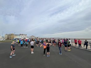 Looking along the course at Hartlepool Parkrun above participants at the start line on a clear day